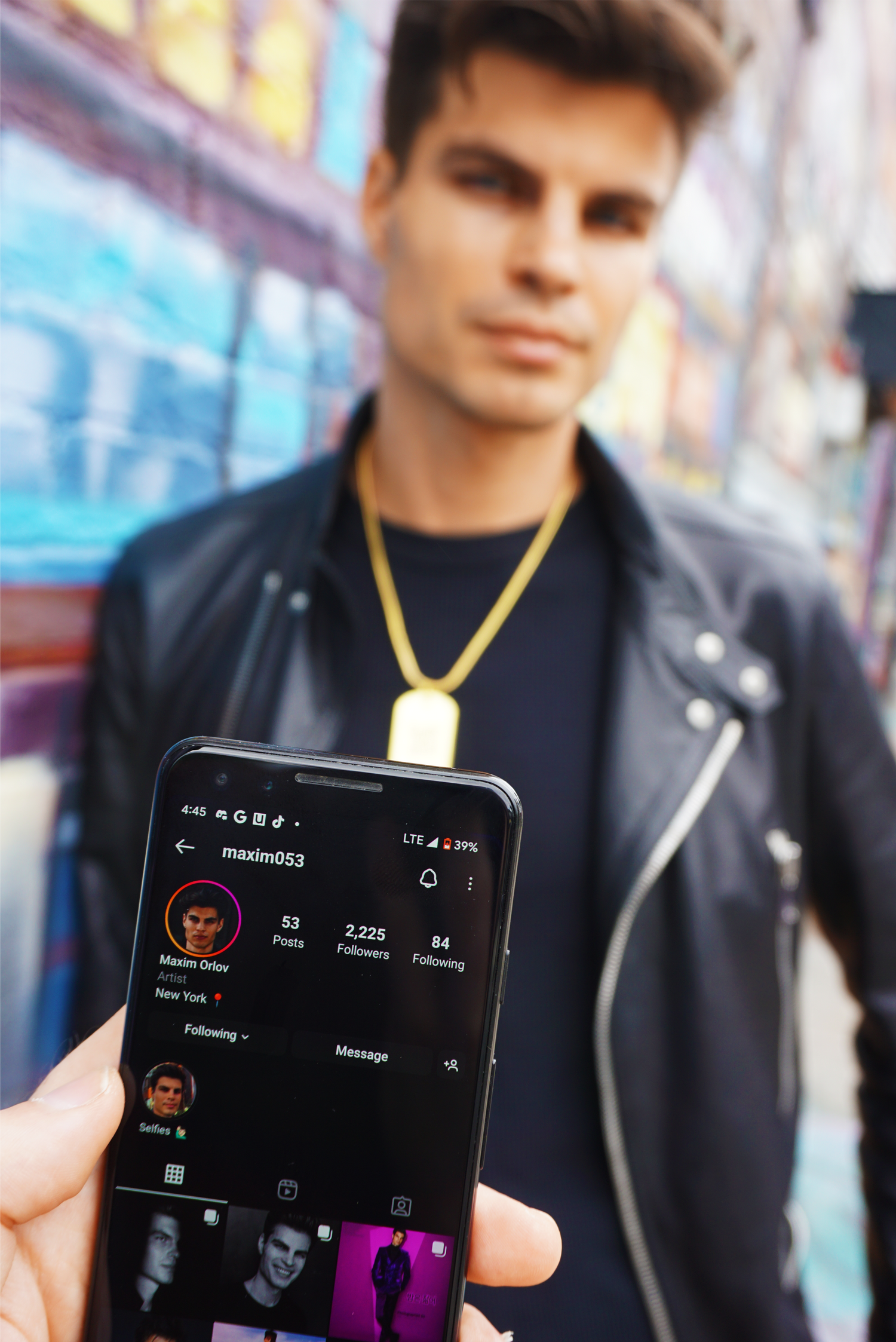 Max Taylor wearing a golden Jumptag, with a close-up phone in foreground displaying his Instagram profile after scanning it